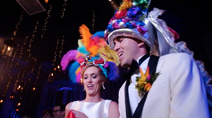 Ali and Andres dancing in carnival headdresses at their 2017 wedding party