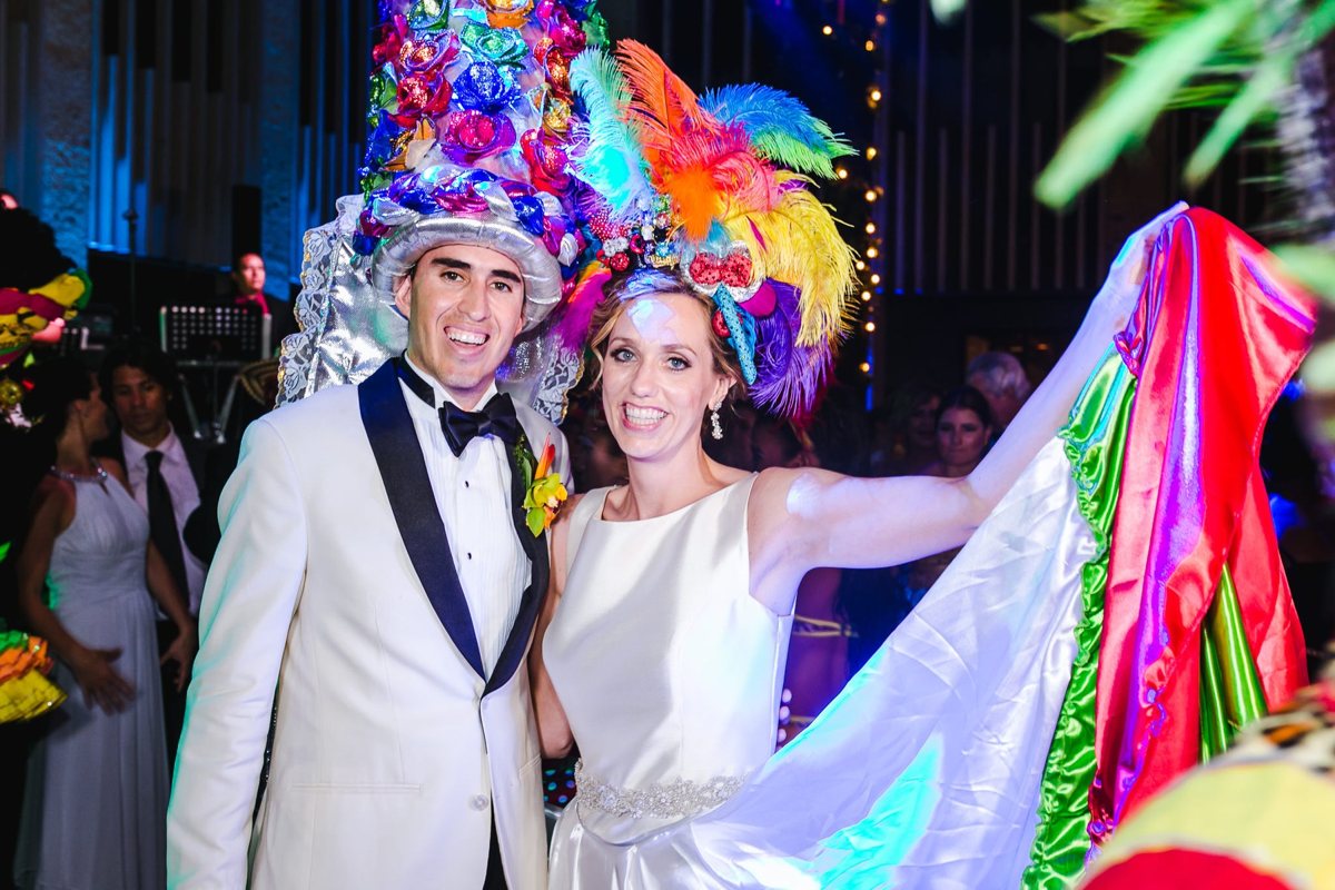 Ali and Andres dancing in festive Colombian carnival headdresses at their wedding party, June 17, 2017